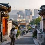 Traveler with a map in a Seoul hanok neighborhood